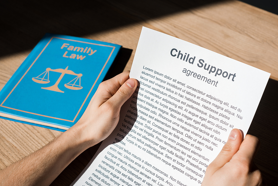 cropped view of man holding document with child support Discrepancies in child support payments